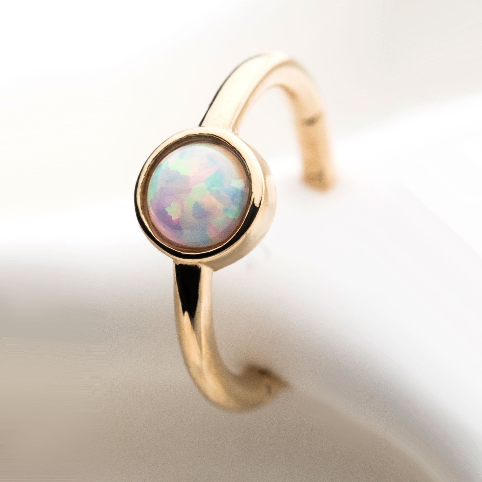 14kt Gold Centered White Synthetic Opal Side Facing Hinged Segment Clicker